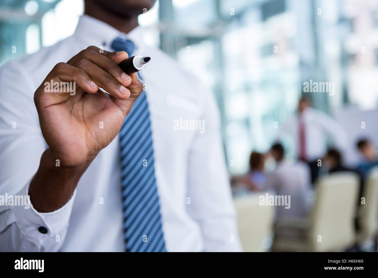 Businessman writing with marker on glass Stock Photo - Alamy