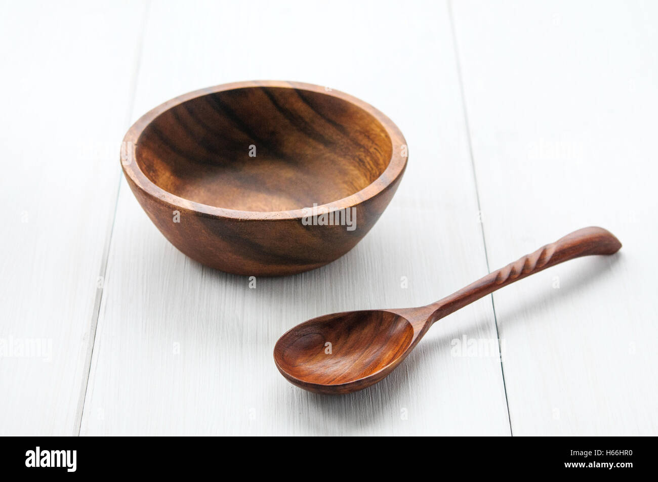 Wooden bowl and spoon on white background Stock Photo - Alamy