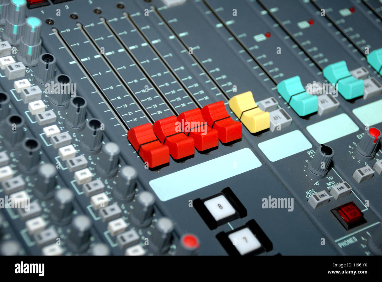 Audio mixing console in a recording studio. Faders and knobs of a sound ...