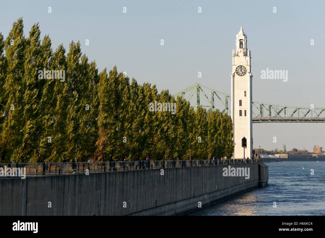 The Clock Tower located on Quai de Horloge with the Jacques Cartier Bridge in back, Old Port of Montreal, Quebec, Canada Stock Photo