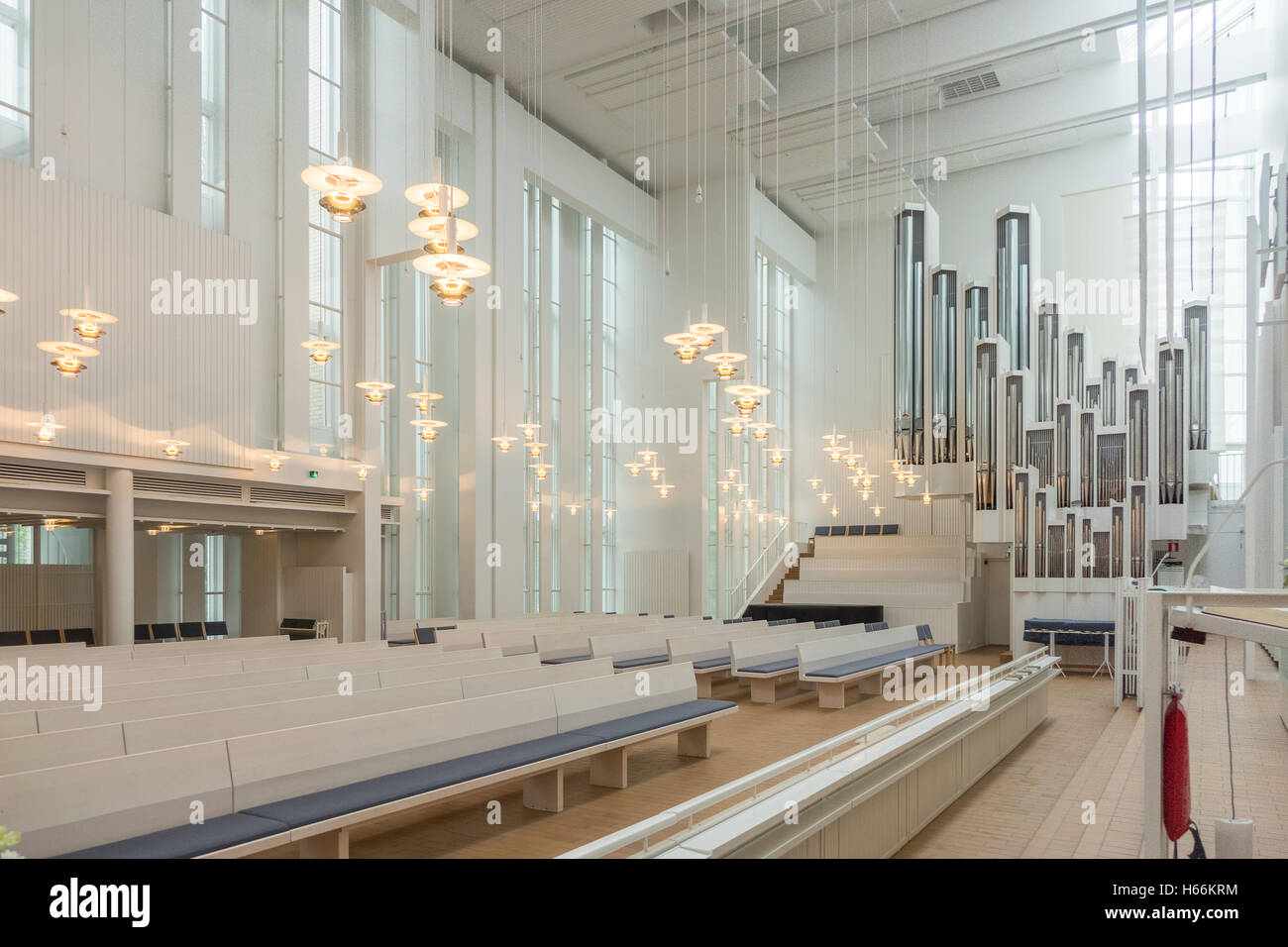 The white interior with strong vertical lines of Myyrmäki Church, Vantaa, Finland, showing organ. Stock Photo
