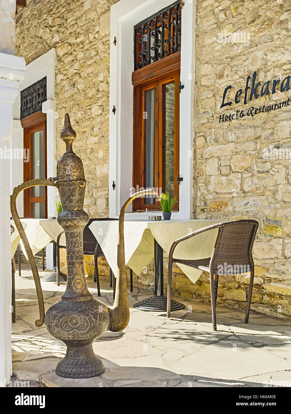 The traditional arabic coffee pot stands next to the entrance of the central restaurant of Lefkara, Cyprus. Stock Photo