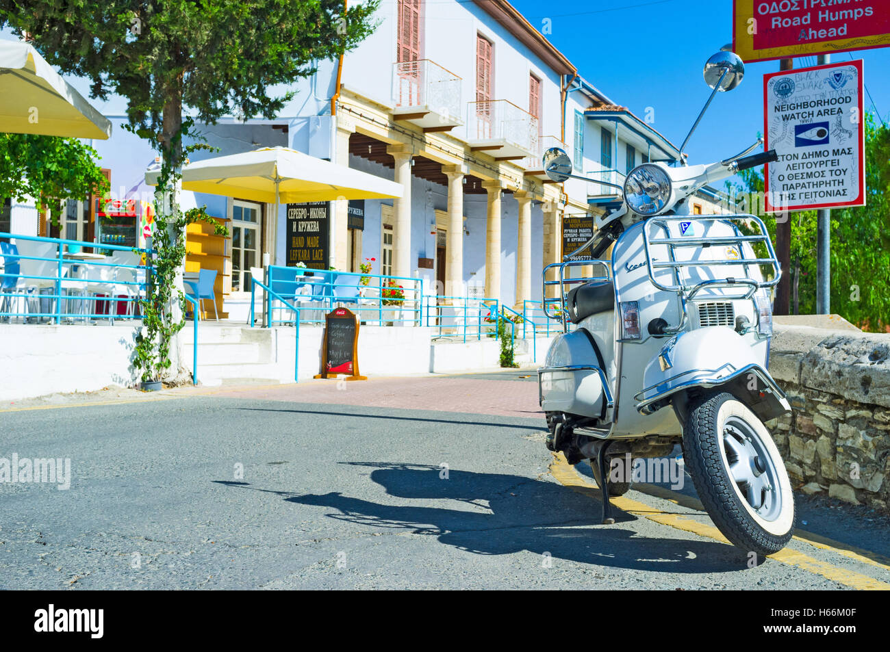 The white scooter parked next to the restaurant, Lefkara. Stock Photo