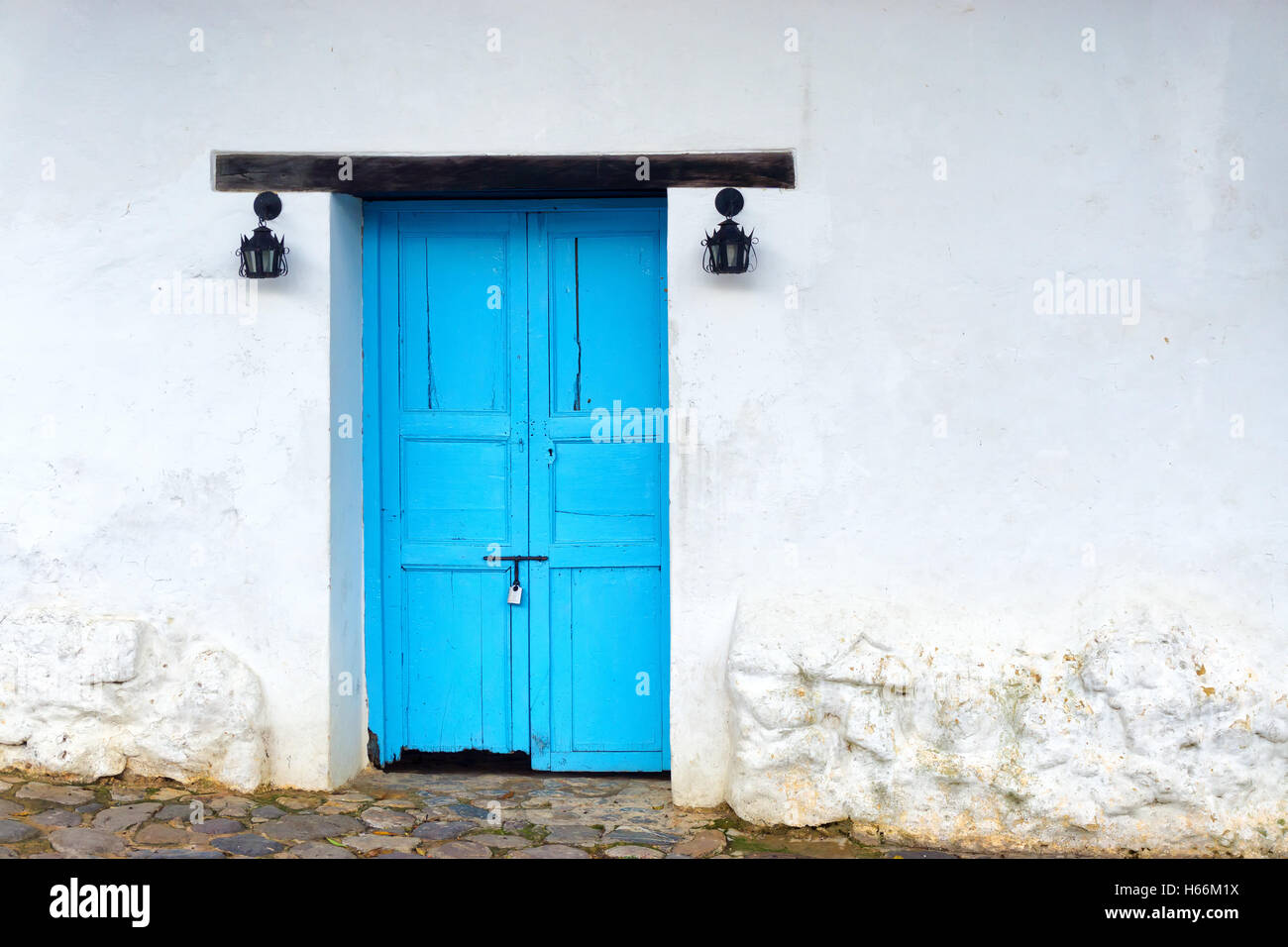 View of old wooden door on white colonial building in Villa de Leyva, Colombia Stock Photo