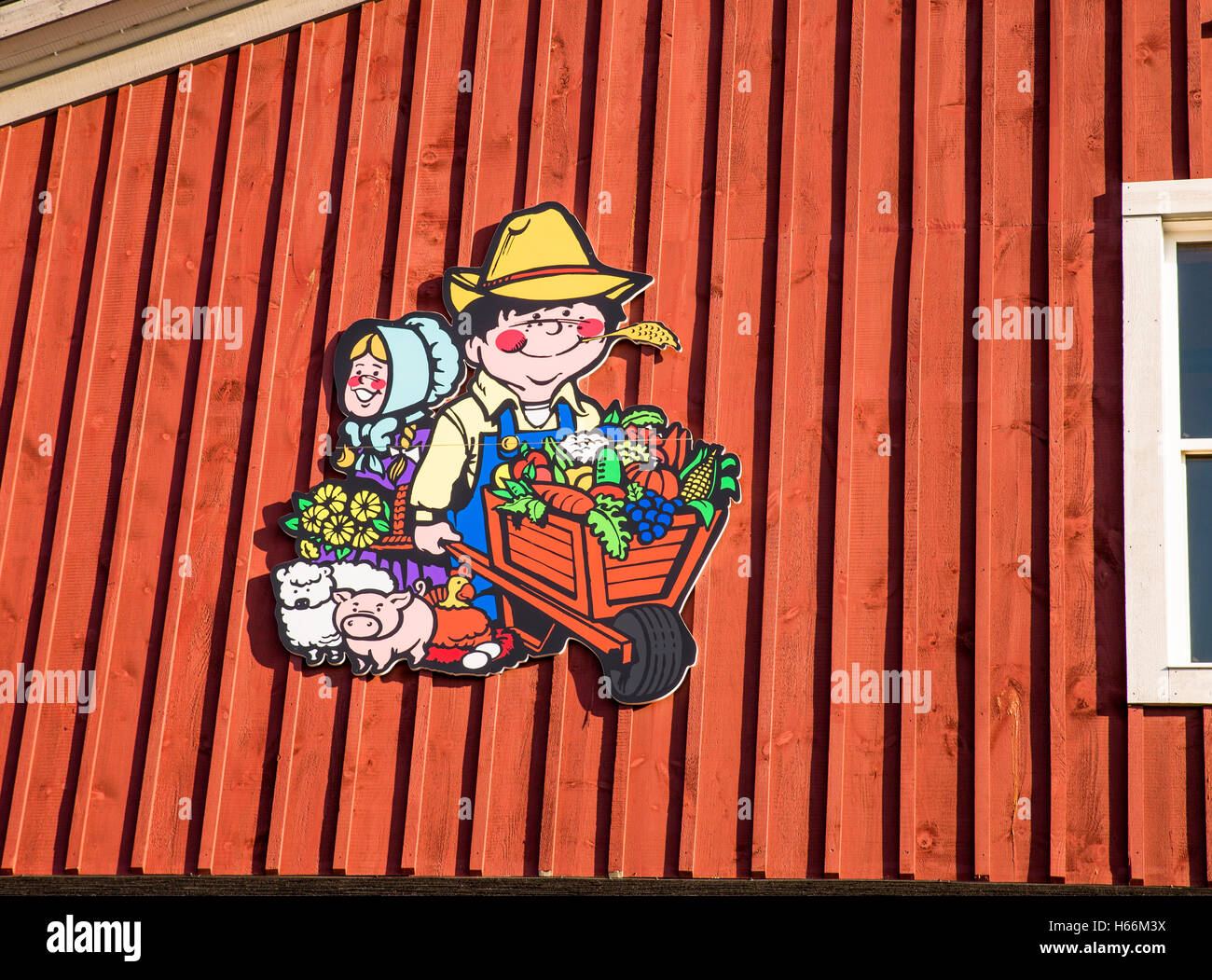 Cartoon farmer with wheelbarrow mascot over the entrance to farmers' market, Waterloo Canada Stock Photo