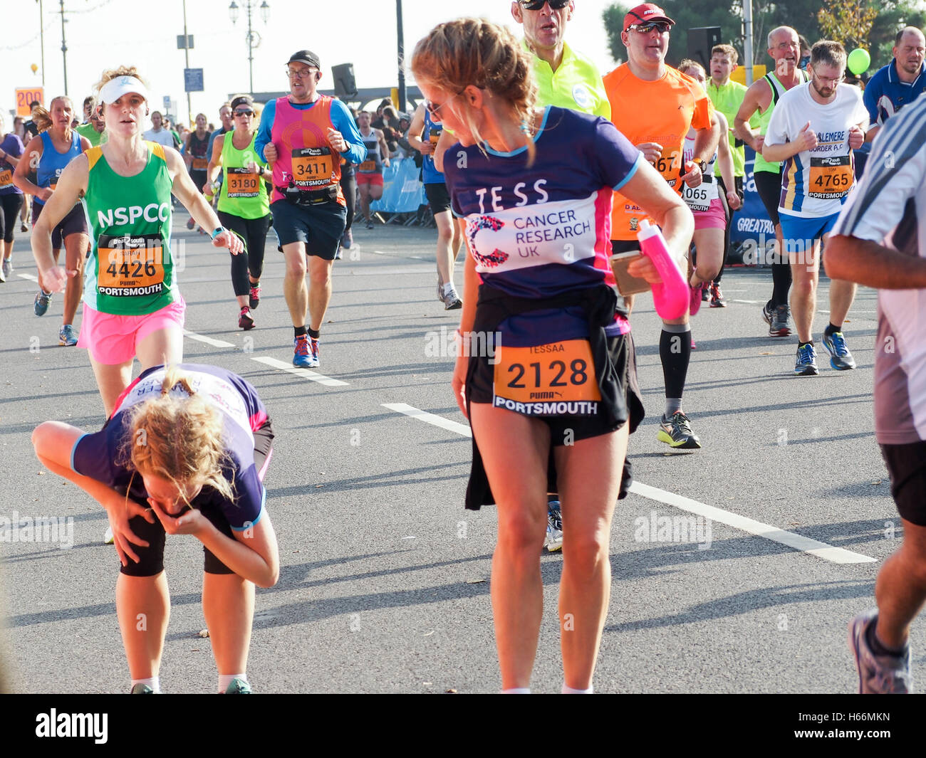 A runner vomits during the final straight of the Great South Run Stock Photo