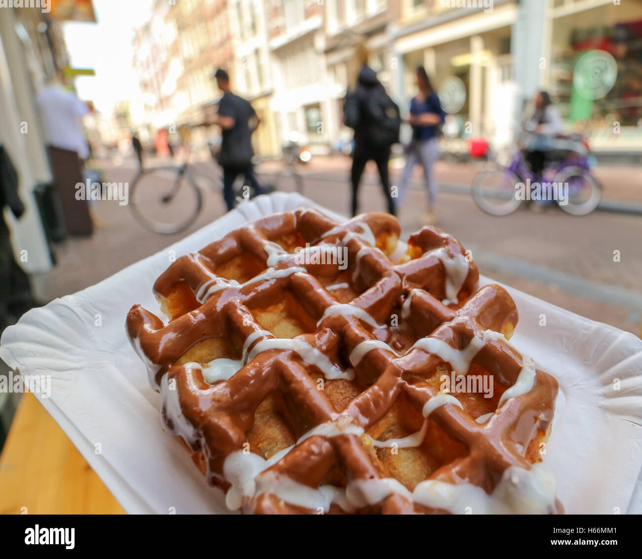Eating a fresh Belgium waffle on Amsterdam street Stock Photo Alamy