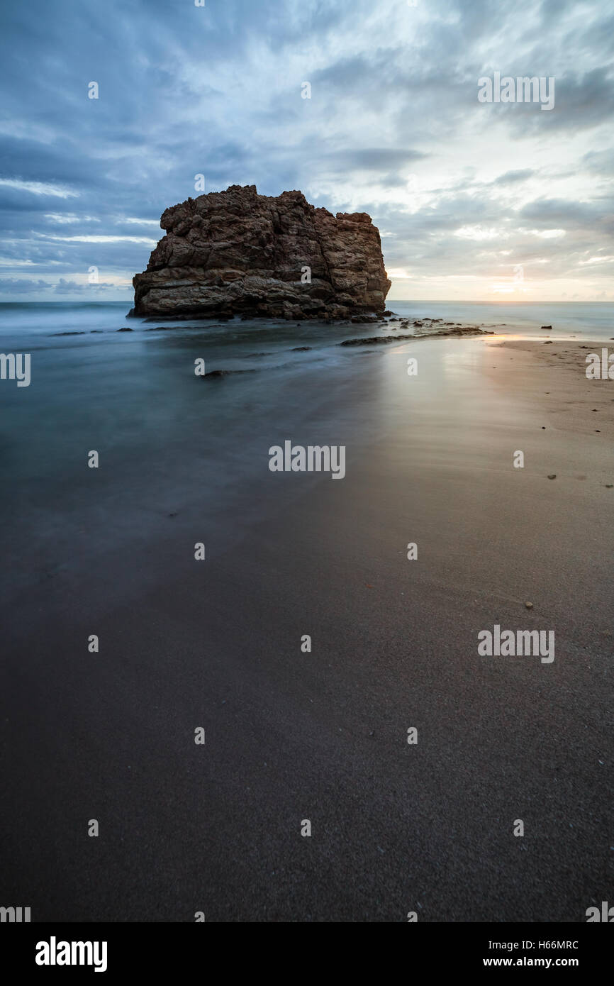 Big rock beach sunset long exposure Stock Photo - Alamy