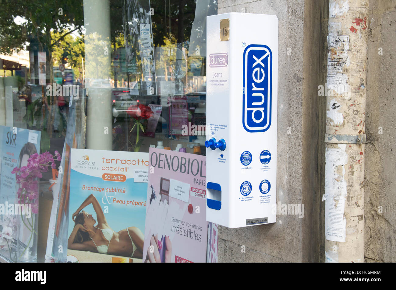 Contraception, chemist shop. A wall mounted vending machine dispensing Durex condoms outside a pharmacy on a Parisian street, Paris, France. Stock Photo