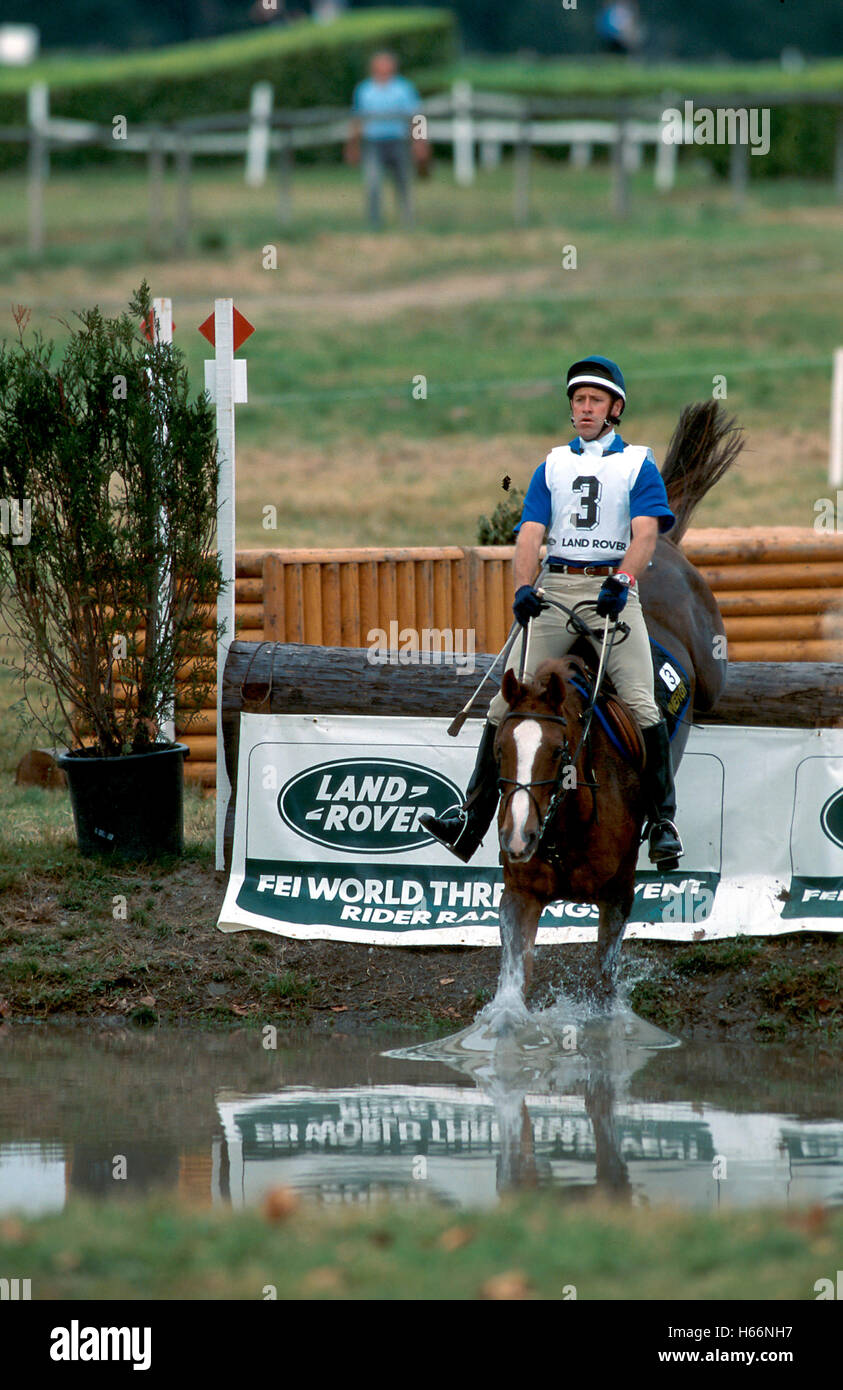 Andrew Hoy of Australia riding Goldfields into the lake at the CCI Pau, France, 1990 Stock Photo