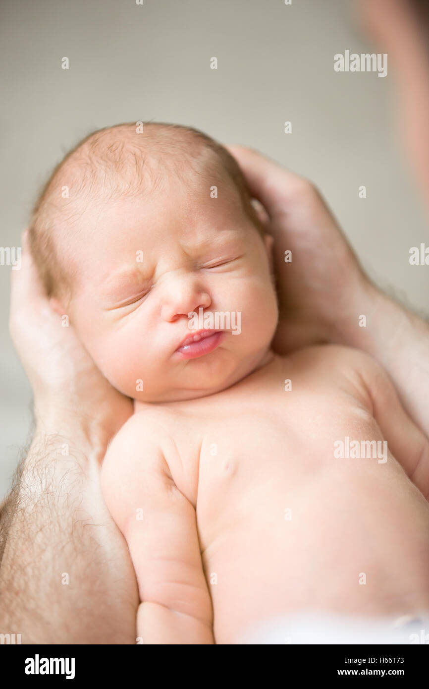 Portrait of a newborn hold in palms Stock Photo