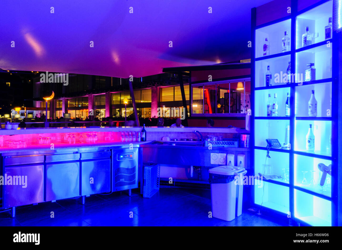 Outside bar at a hotel illuminated with blue and purple lights. Stock Photo
