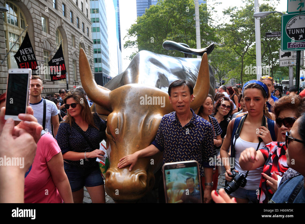 Tourists at Wall Street Bull, Lower  Manhattan, New York, USA Stock Photo