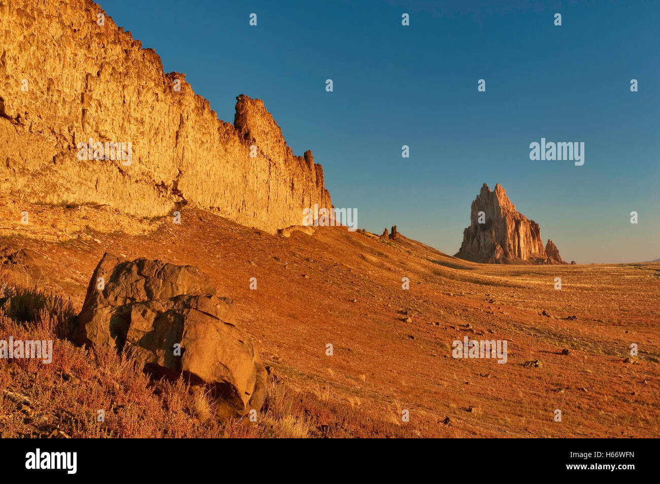 Shiprock, sacred Navajo mountain, monolith, dike ridge on left, at sunrise, New Mexico, USA Stock Photo