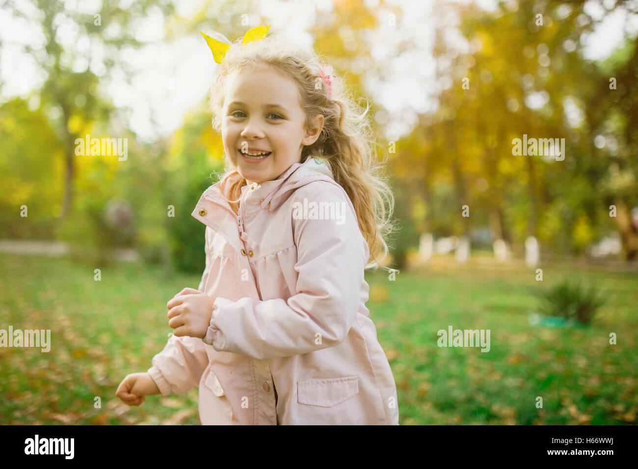 Happy child girl having fun in autumn park Stock Photo