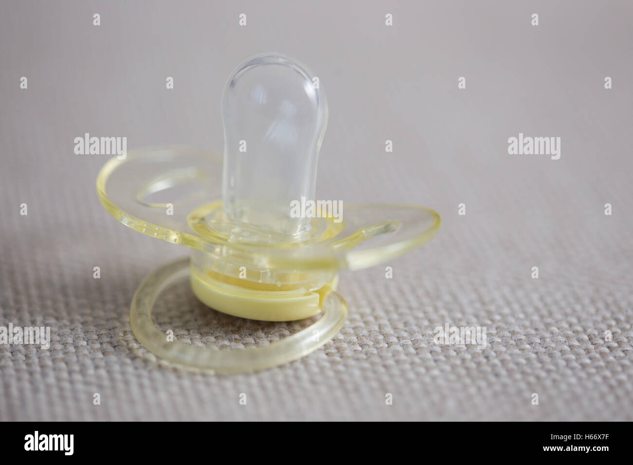 Silicone pacifier on gray textile background Stock Photo