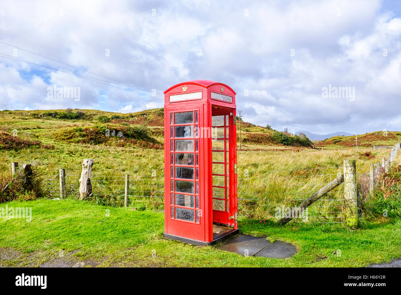 Red telephone box without a door in a remote rural location on the Isle of Skye Scotland Stock Photo