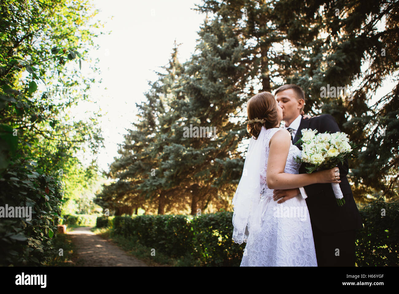 couple bride and groom on a park background Stock Photo - Alamy