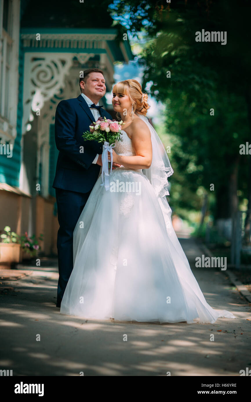 bride and groom on the background of the city Stock Photo - Alamy