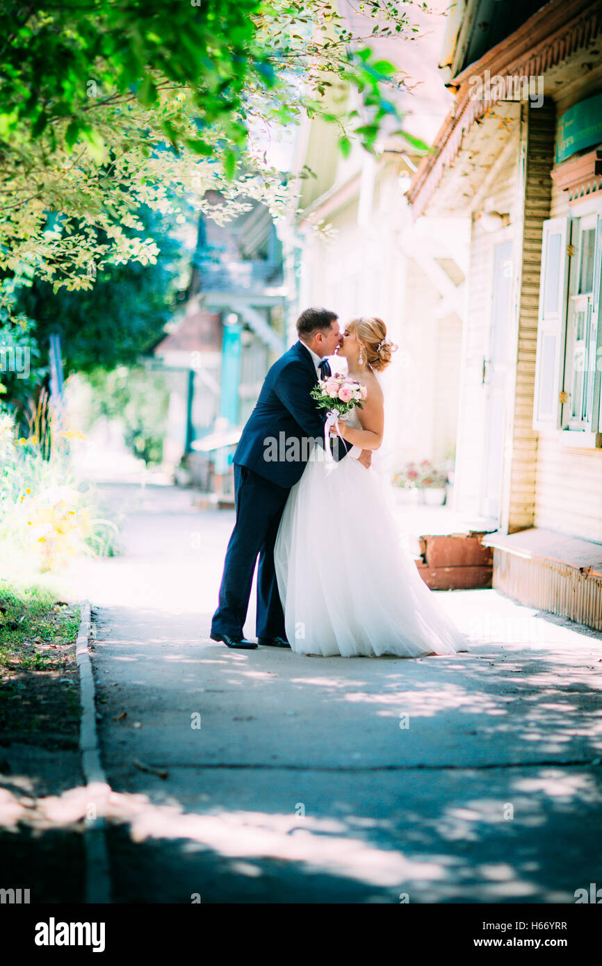 bride and groom on the background of the city Stock Photo - Alamy
