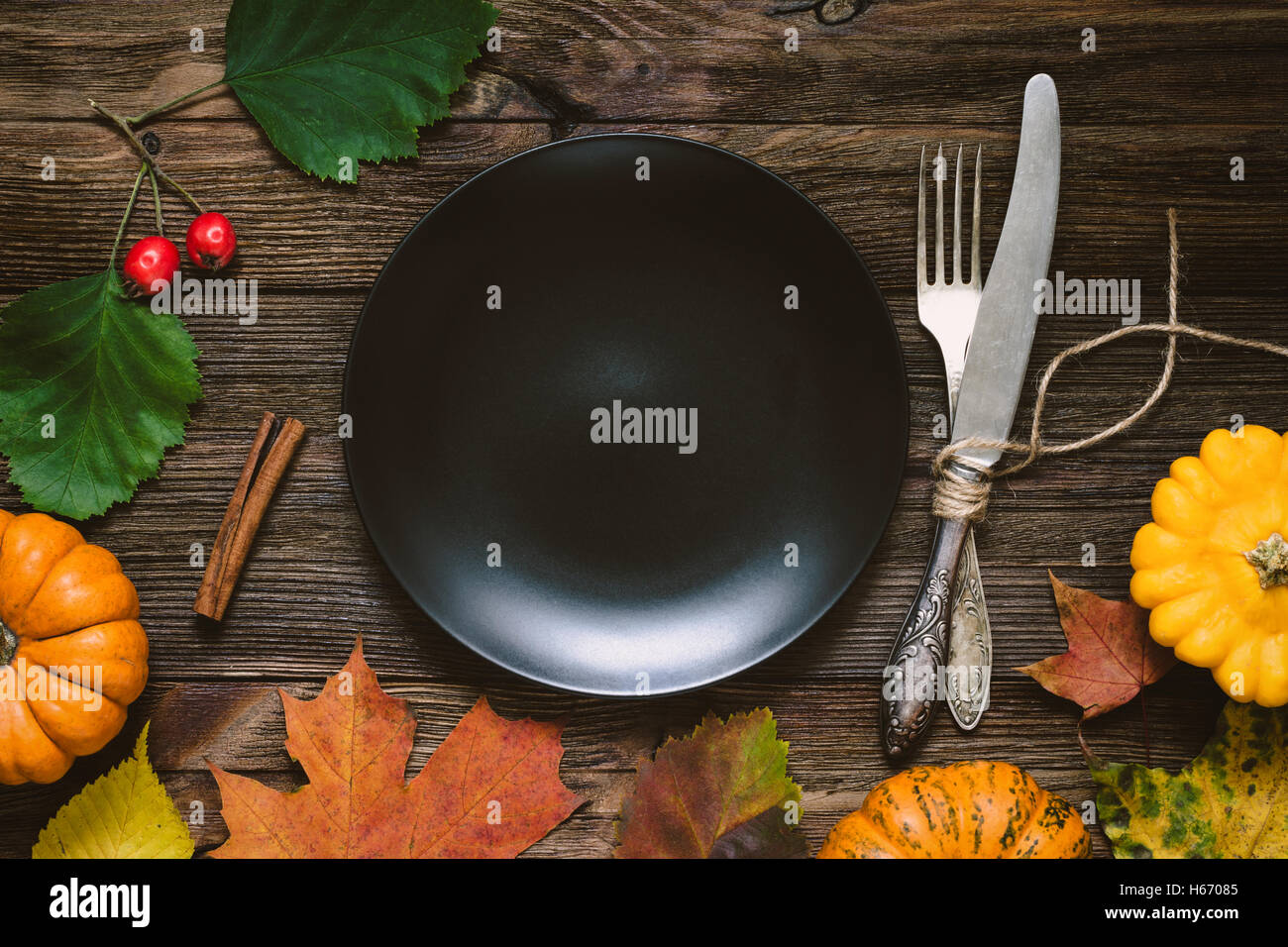 Autumnal table setting for Thanksgiving dinner, Halloween. Blank black ...