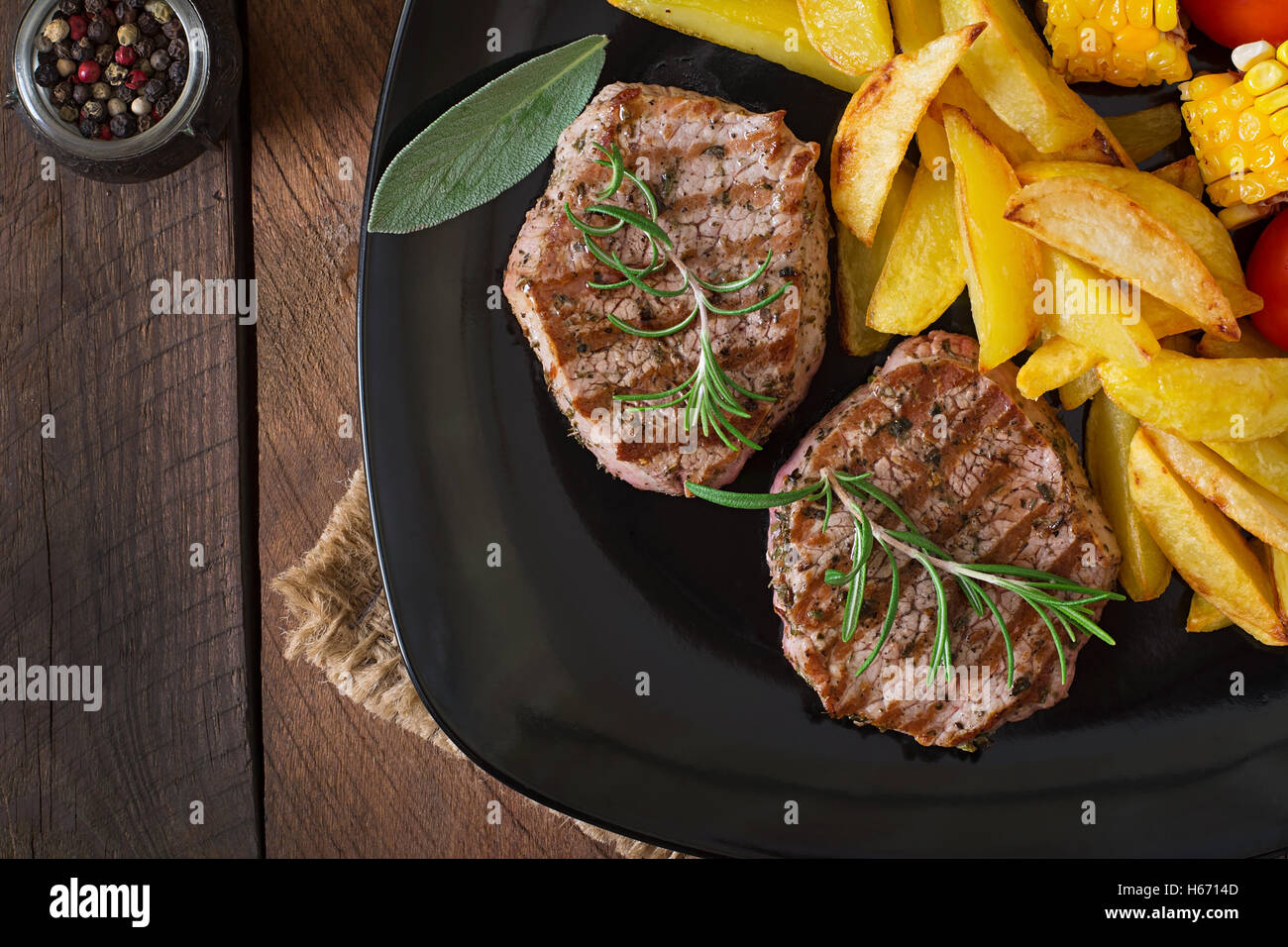 Tender and juicy veal steak medium rare with French fries. Top view Stock Photo