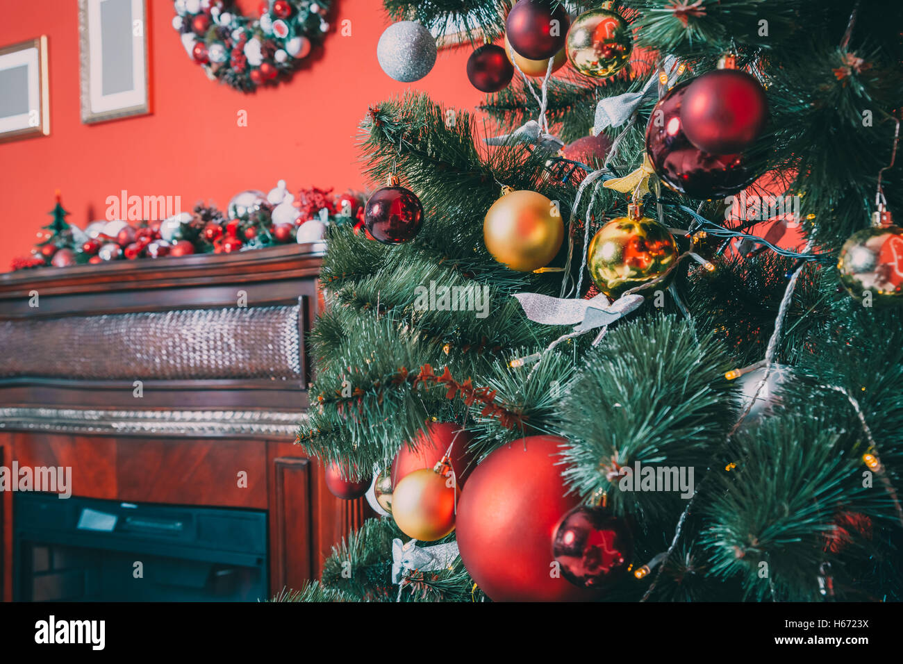 Beautiful new year room with decorated Christmas tree and fireplace. The idea for postcards. Soft focus. Shallow DOF Stock Photo