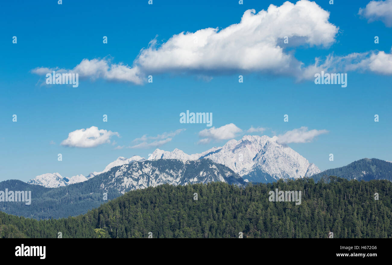 Mountain landscape view with some clouds and a forest. Stock Photo