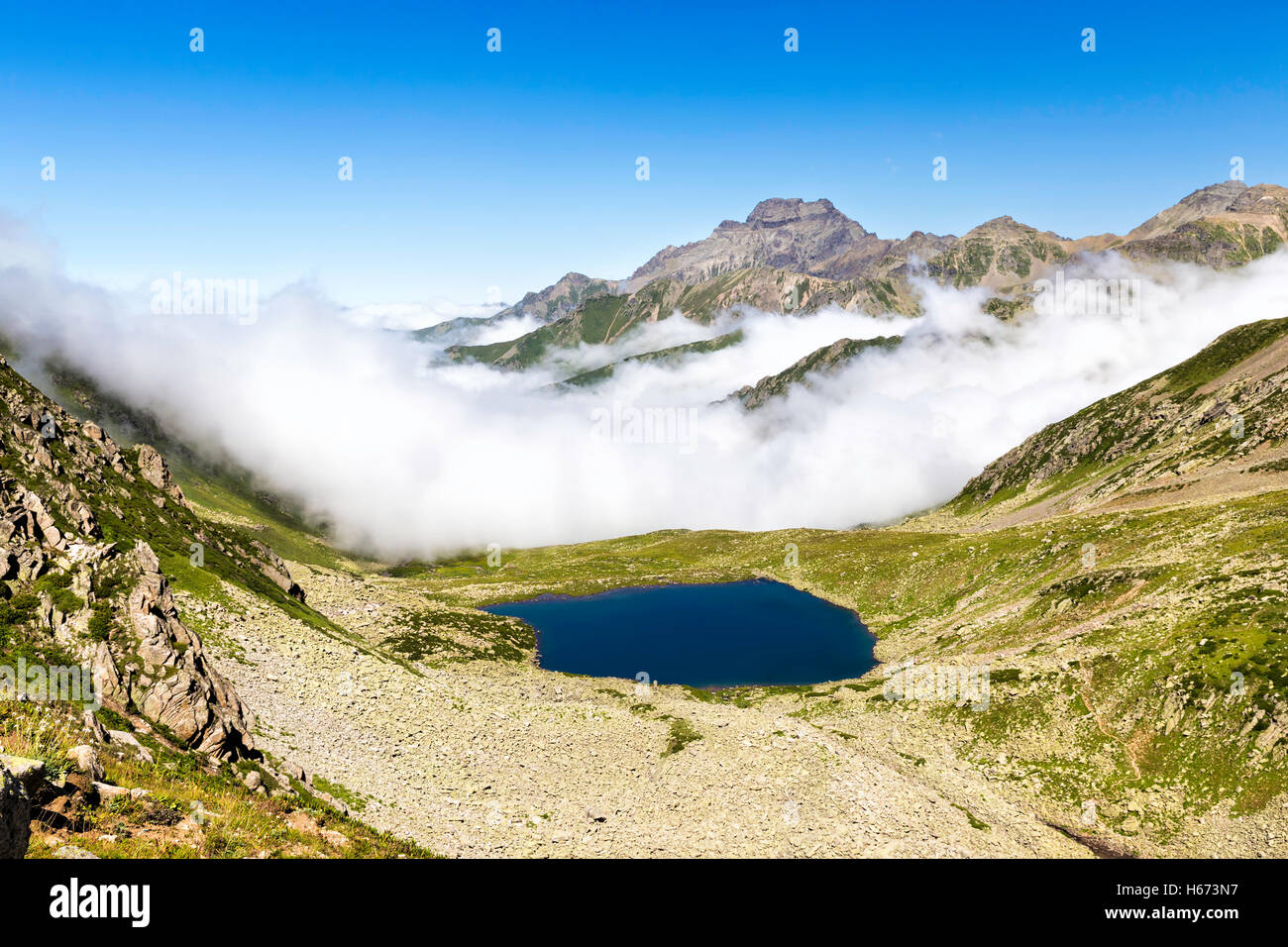 Panoramic view of glacial lake with foggy mountain background on the top of the Kackar Mountains or simply Kackars, in Turkey. Stock Photo