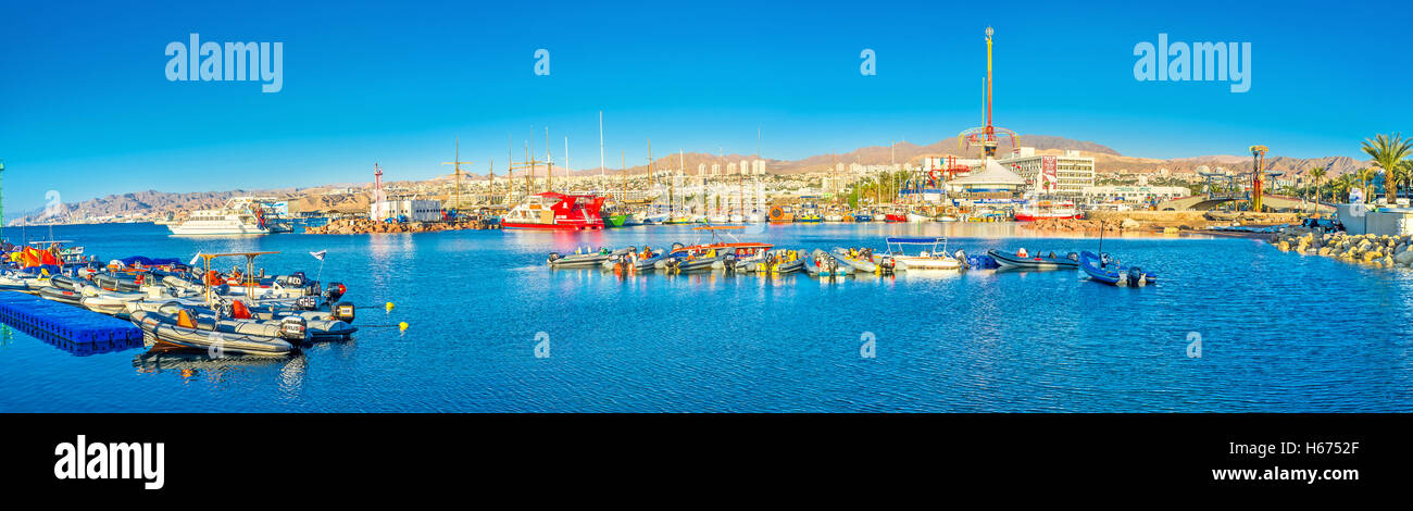 Panorama of resort with the large harbor, amusement park and scenic rocky mountains on the background, Eilat Stock Photo