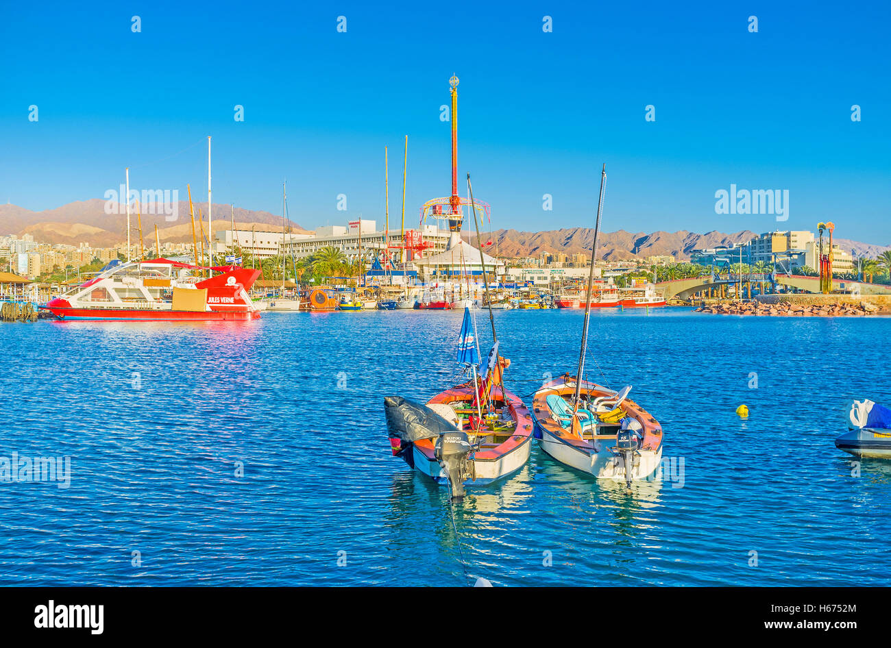 The city center with amusement park, harbor and the rocky mountains on the background, Eilat Stock Photo