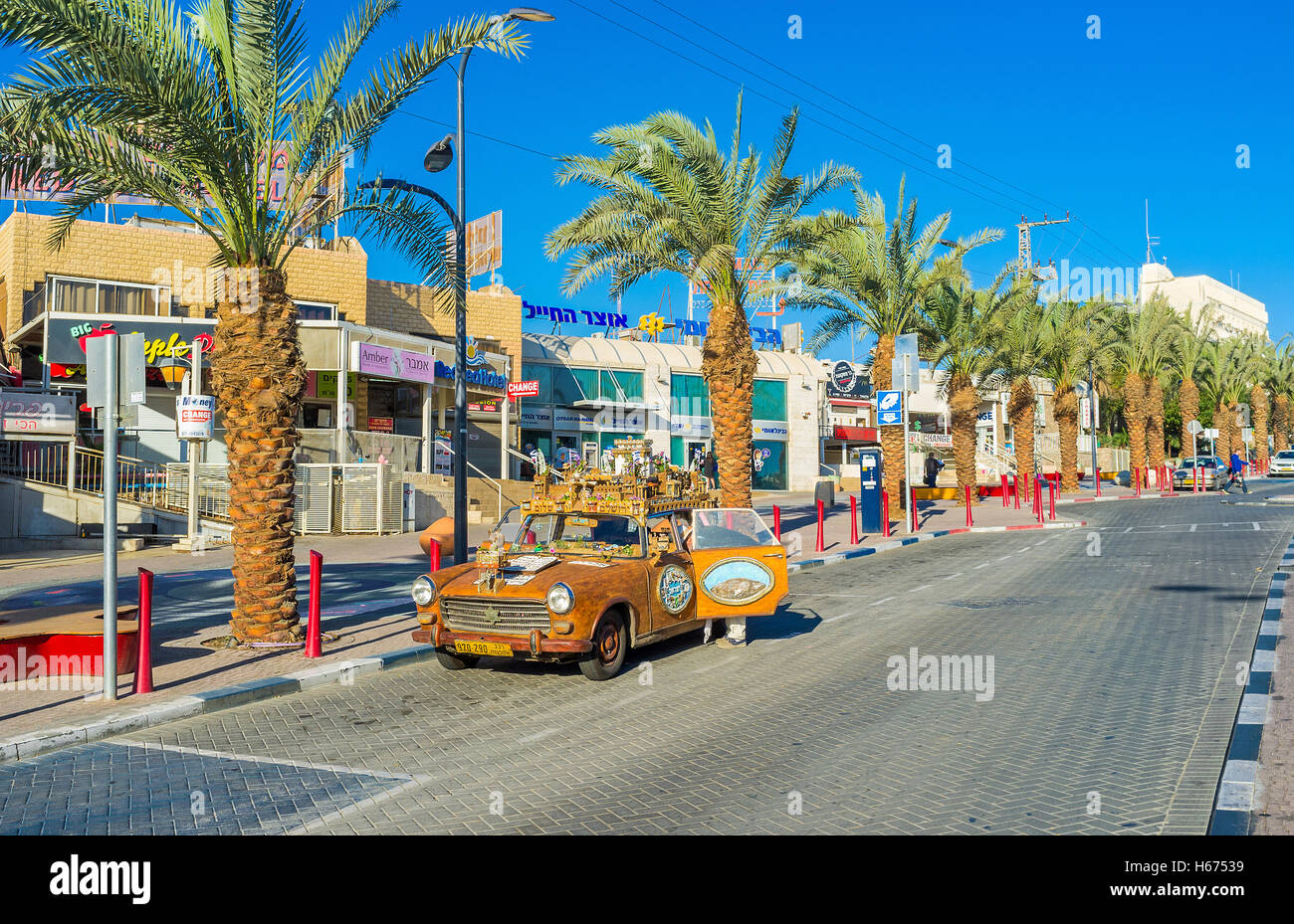 The tourist car decorated with the model of the medieval town-fortress and colorful reliefs, Eilat Stock Photo