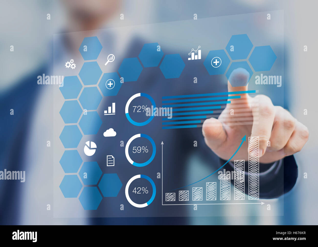 Businessman touching a dashboard with key performance indicator displayed with charts on a virtual screen Stock Photo