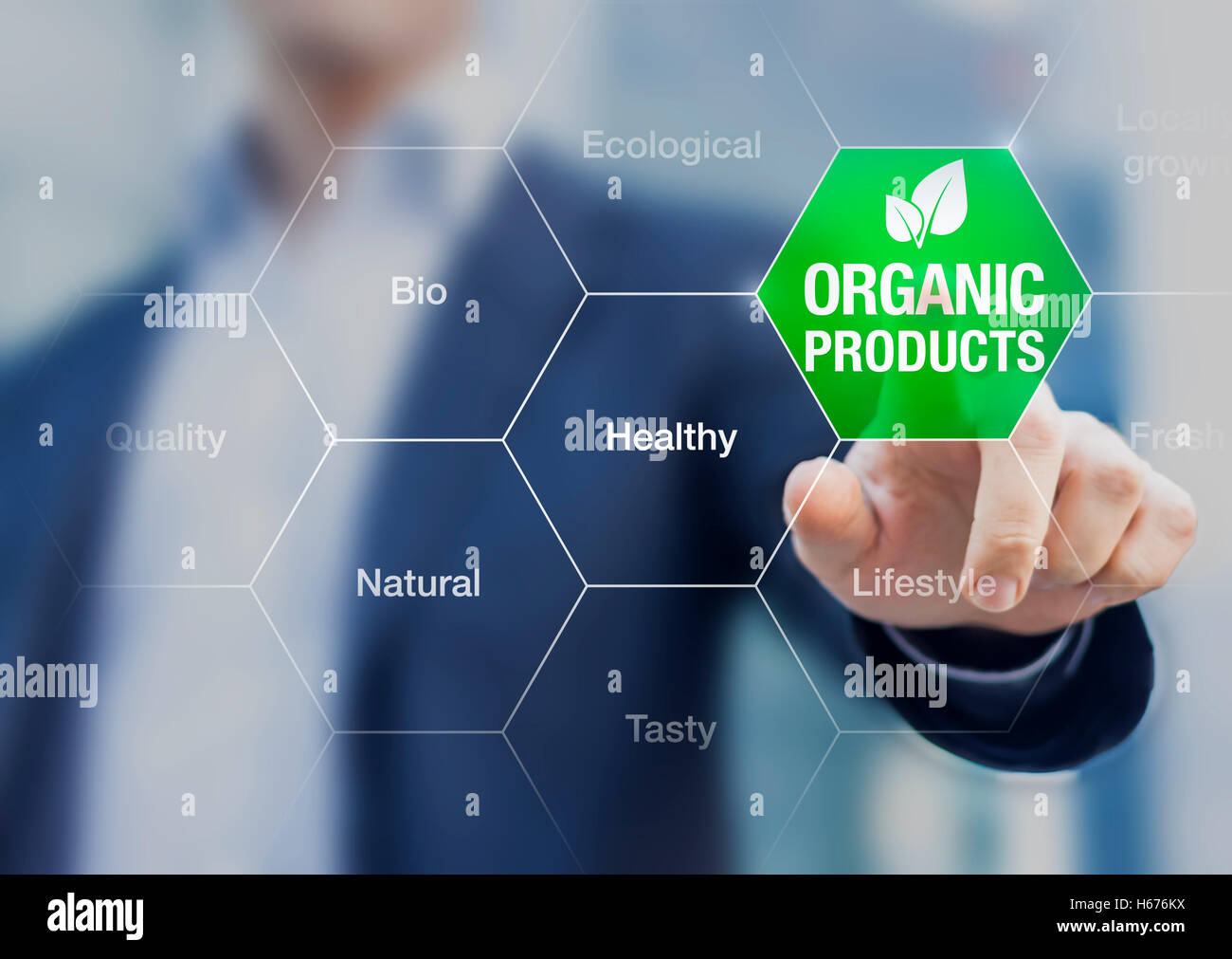Organic products concept, businessman touching green button on interface with words about eating healthy natural food Stock Photo