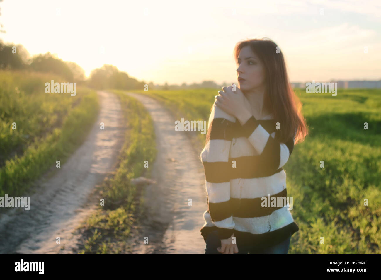 girl fashion in the field on sunset Stock Photo - Alamy