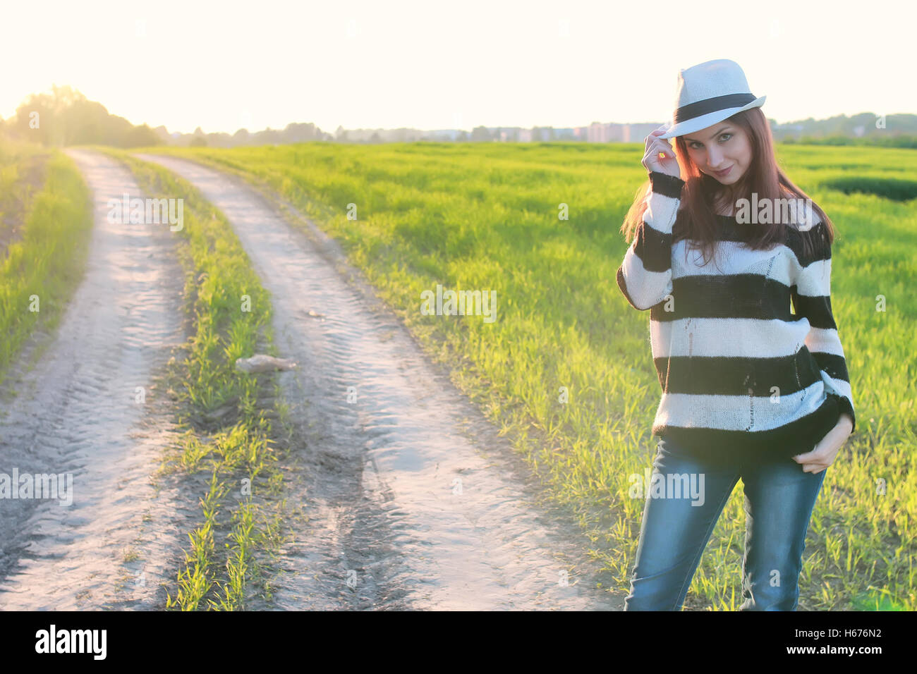 girl fashion in the field on sunset Stock Photo - Alamy
