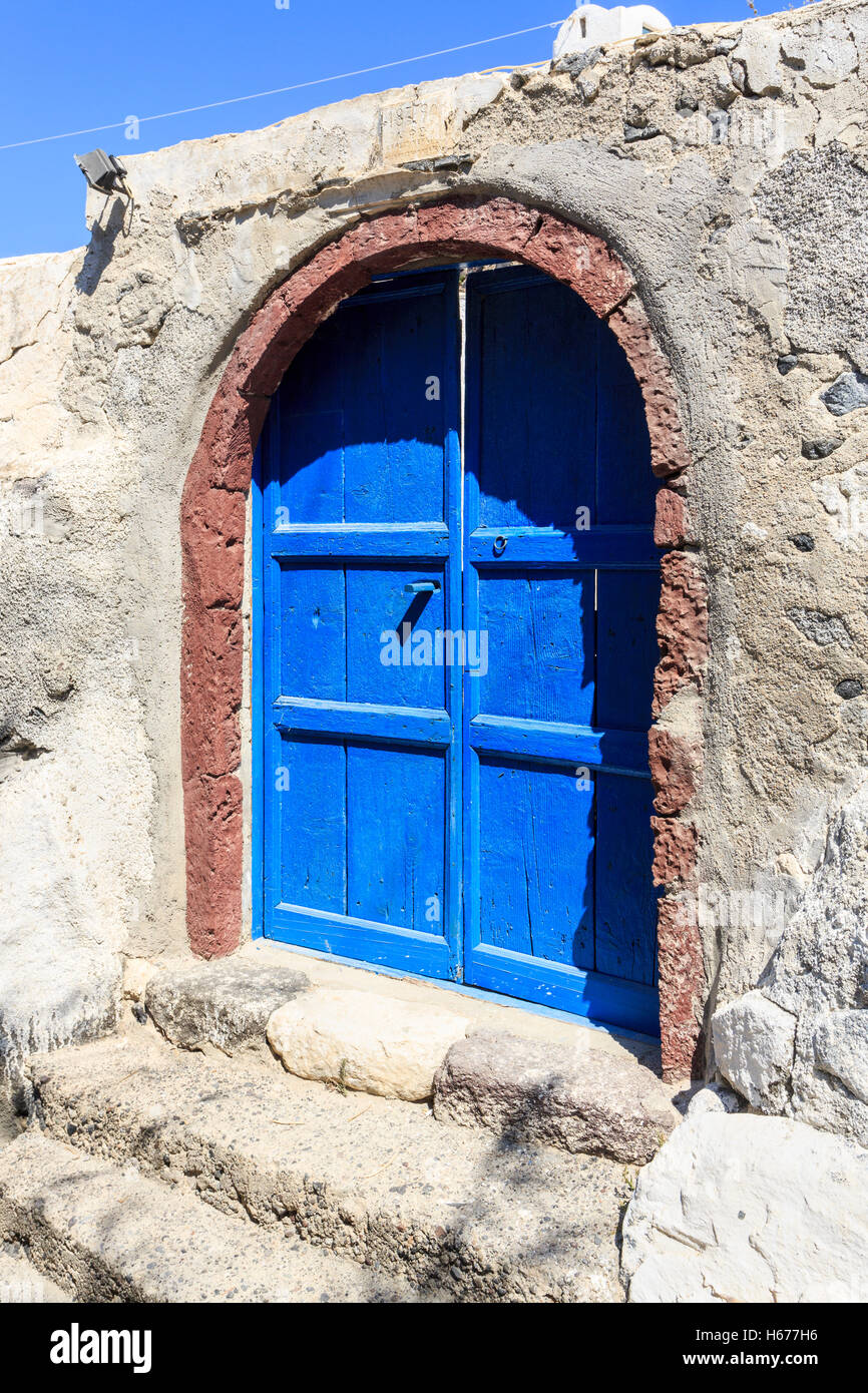 Blue wooden doors and concrete steps at the Church of Panagae, St Mary the Virgin, Agrillia, a village in Thirassia, Santorini Stock Photo