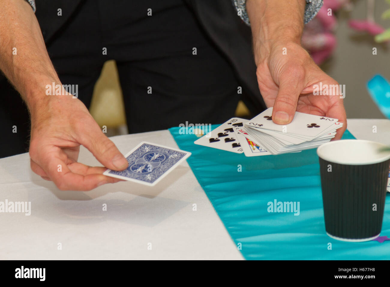 Magician performing a magic trick with a pack of cards Stock Photo Alamy