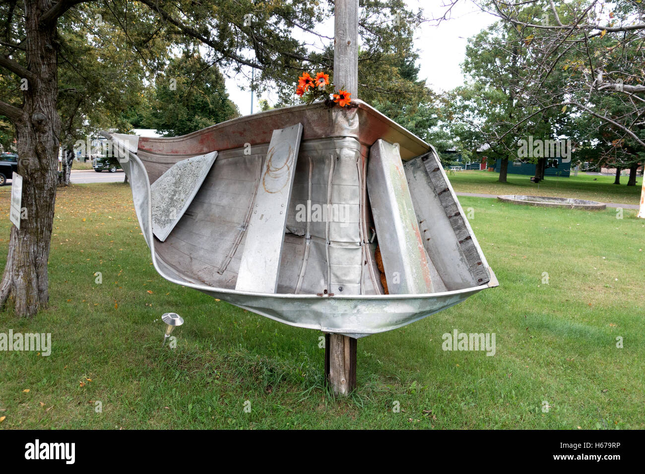 Symbolic aluminum rowboat wrapped around pole resulting from June 18