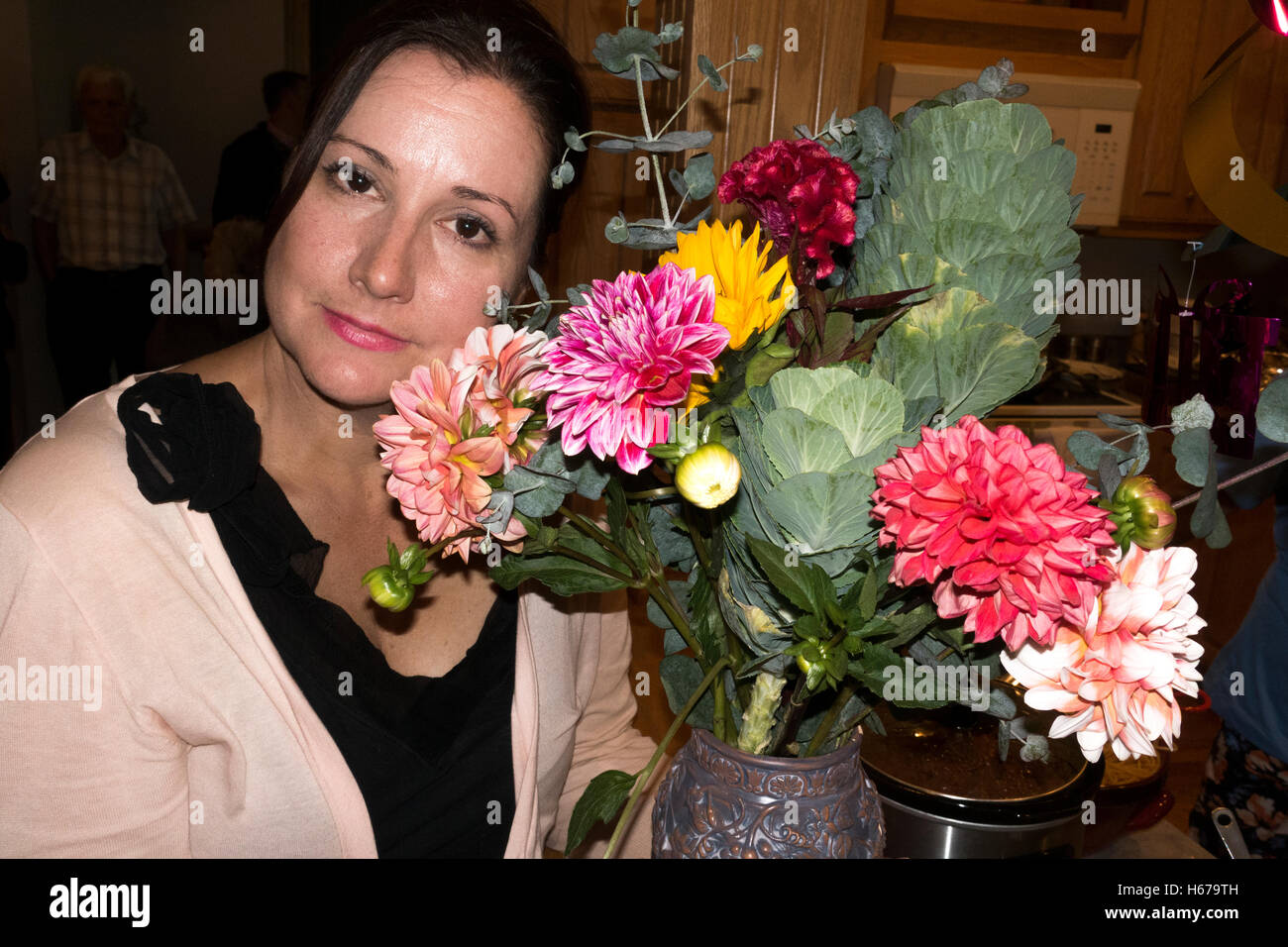 Thoughtful woman posing by a beautiful bouquet of azalea flowers