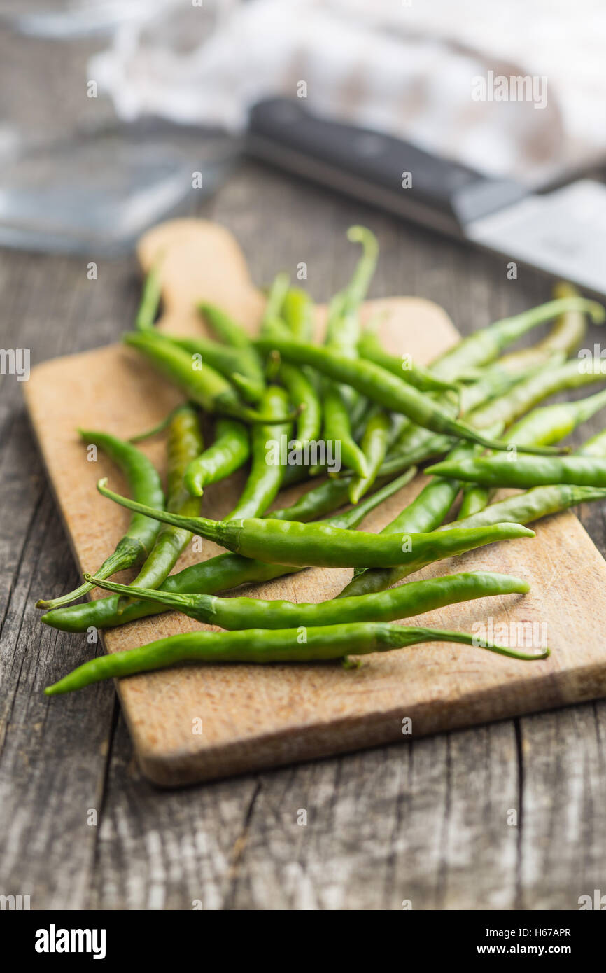 Green chili peppers on cutting board Stock Photo - Alamy