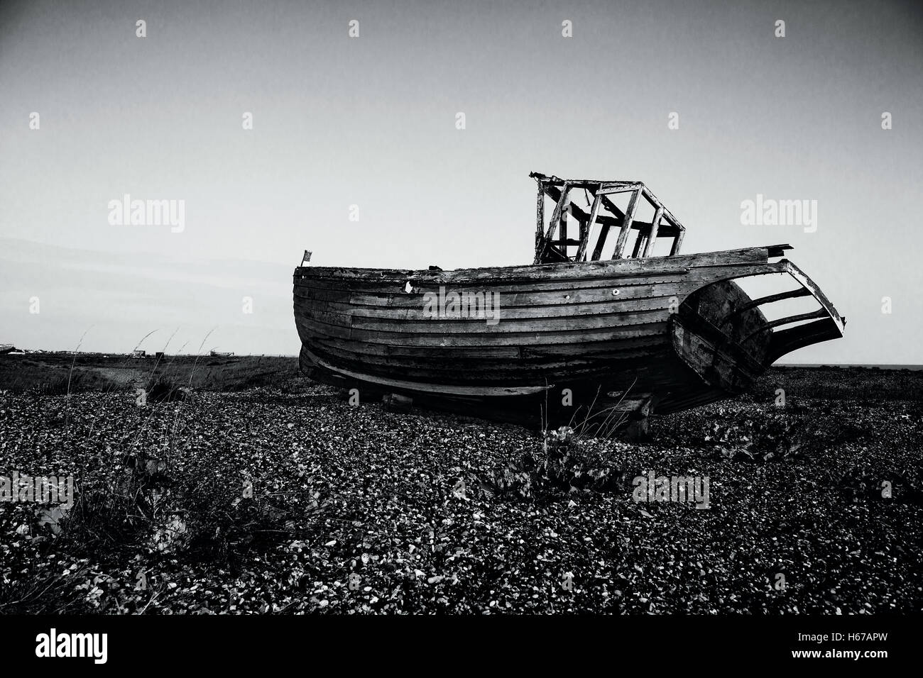 Vessel in the boat graveyard at Dungeness rendered in Black and White Stock Photo