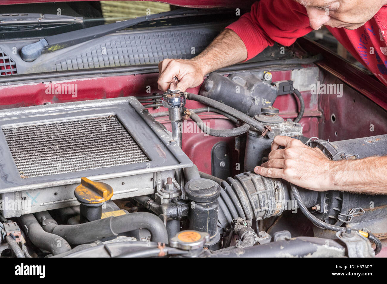 Mechanic working on car engine hires stock photography and images Alamy