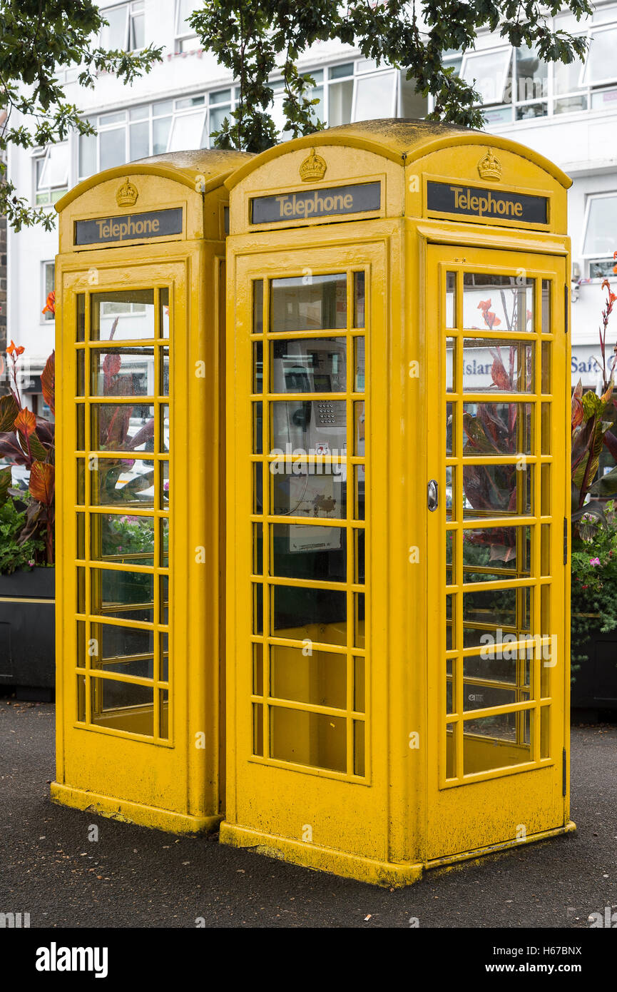 Two yellow telephone kiosks situated in St. Peter Port, Guernsey, Channel Islands. Stock Photo