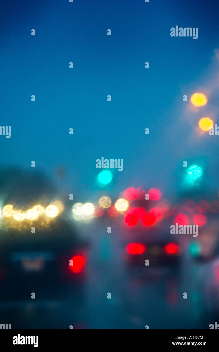 Blurred image of a car driving in the rain at night Stock Photo