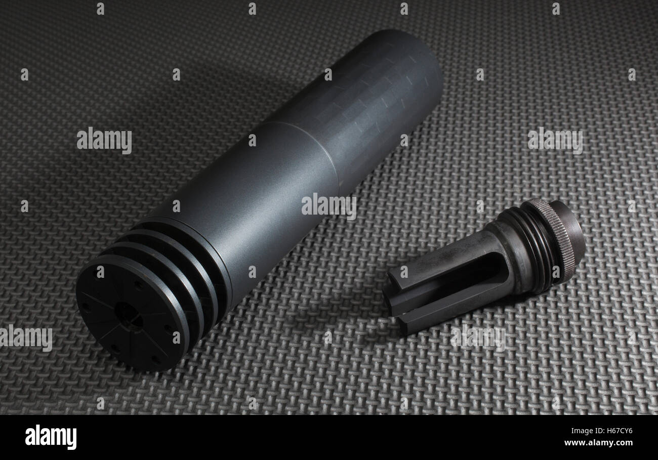 Silencer and the adapter used to hold it on a gun Stock Photo - Alamy