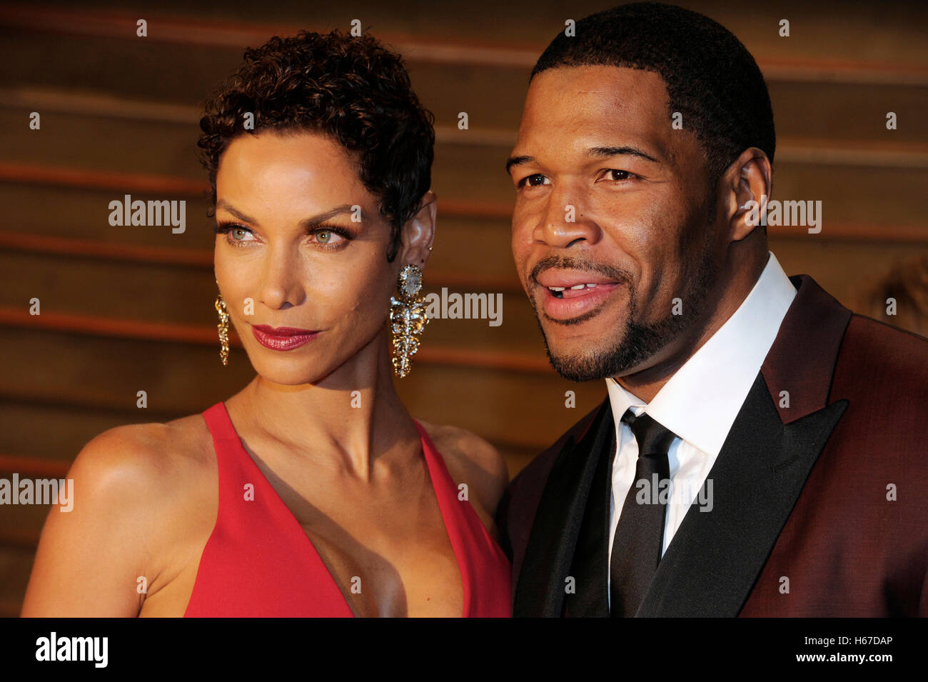 Nicole Murphy (l) and Michael Strahan attends the 2014 Vanity Fair Oscar Party on March 2, 2014 in West Hollywood, California. Stock Photo