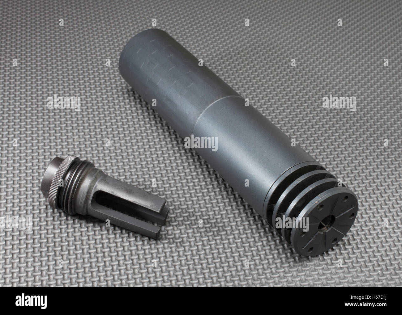 Suppressor and its barrel mount on a grey background Stock Photo - Alamy