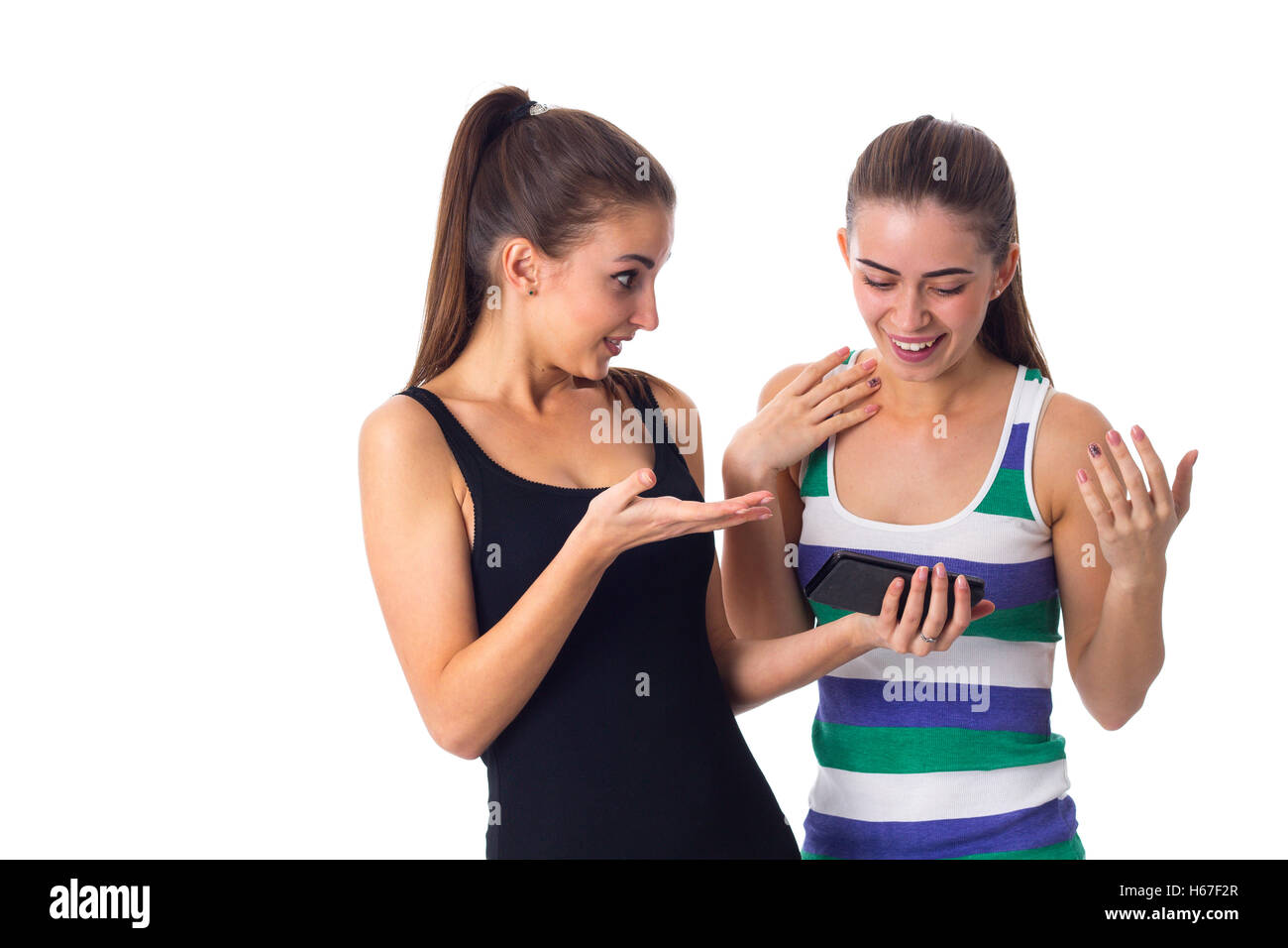 Two young women using smartphone Stock Photo - Alamy