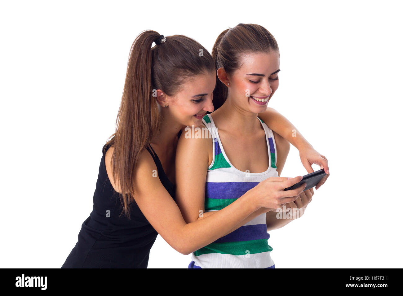 Two young women using smartphone Stock Photo